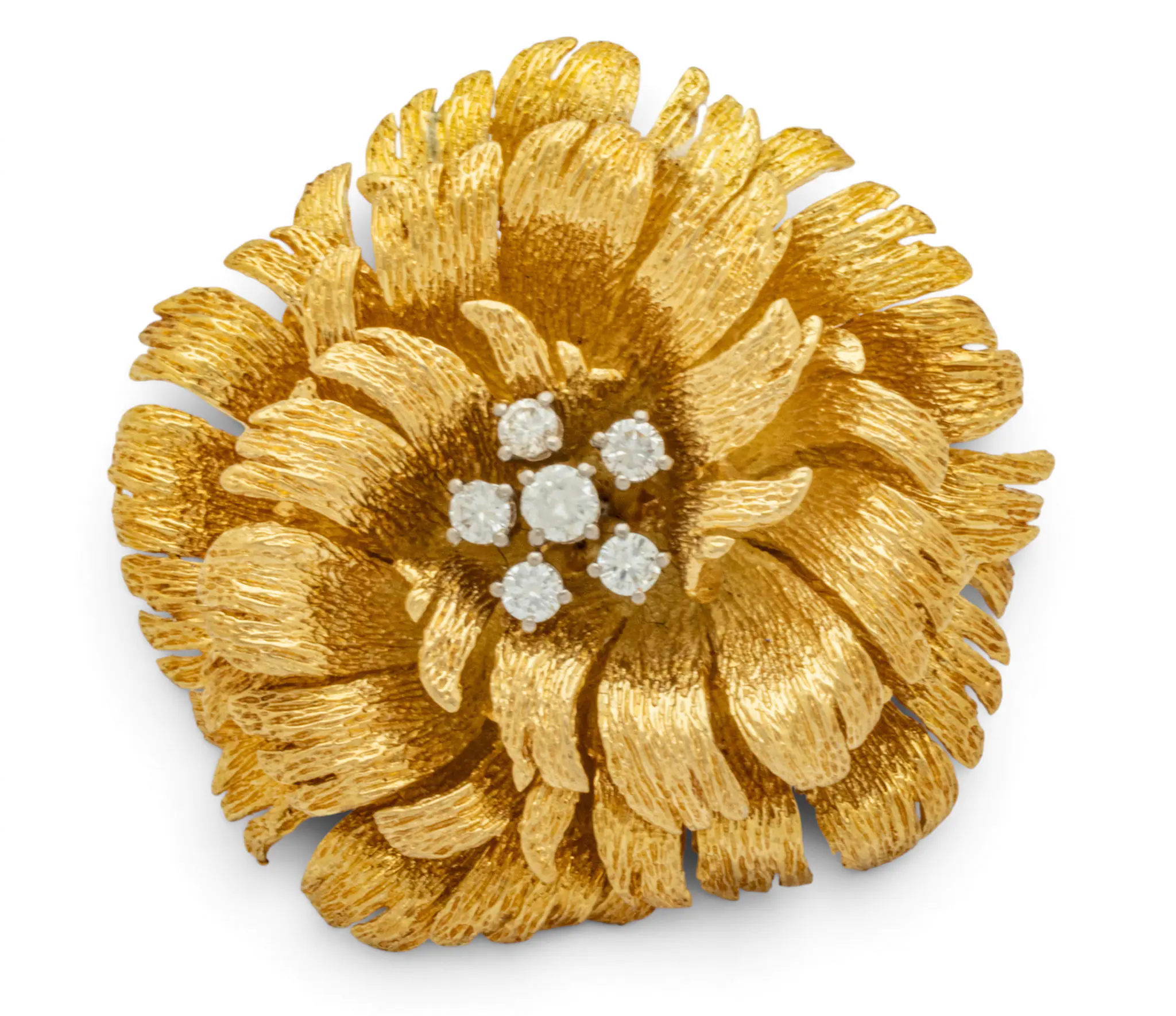Close-up of a gold textured flower ornament with a center cluster of clear crystals/a rhinestone centerpiece