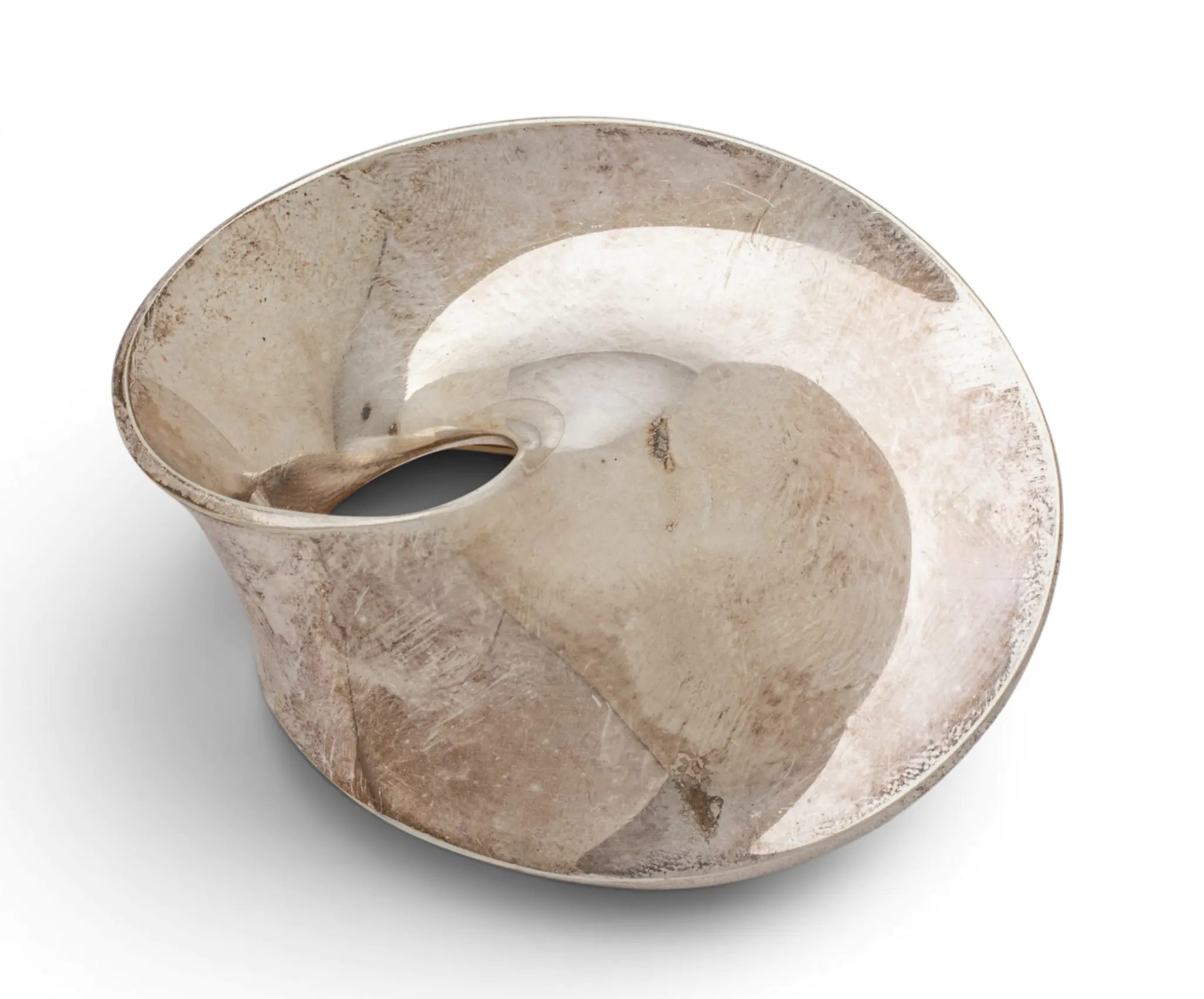 Close-up of a weathered beige metal ring with a rough, scratched surface and circular opening against a white background.