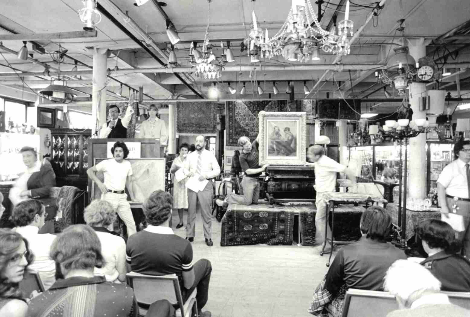 DuMouchelles Gallery, presenting a painting during the auction
