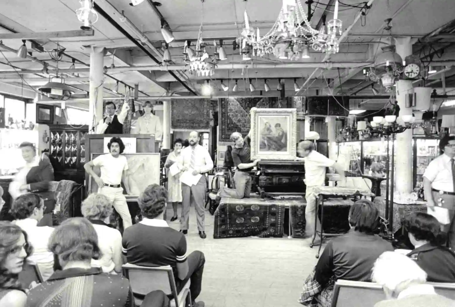 DuMouchelles Gallery, presenting a painting during the auction